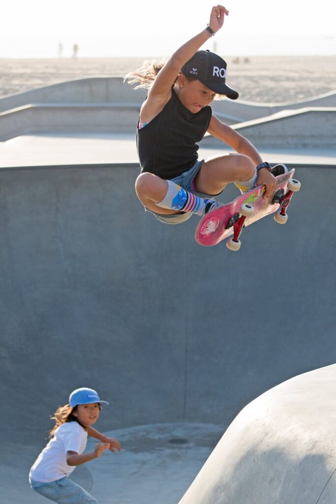 kid on skateboard doing jump off ramp